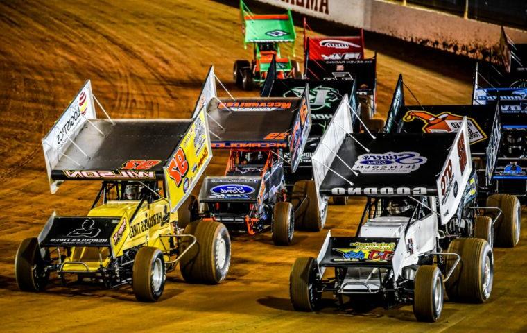 cars racing on a dirt track